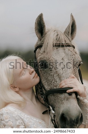 Similar – Image, Stock Photo Portrait of adult woman with beautiful horse in nature. Sunlight, silhouette.Concept of love for lesser brothers, caring and animal training