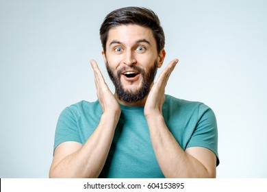 Portrait Of Young Amazed Man Isolated On Gray Background