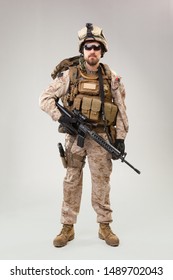 Portrait Of A Young American US Marine Corps Soldier Over Grey Background