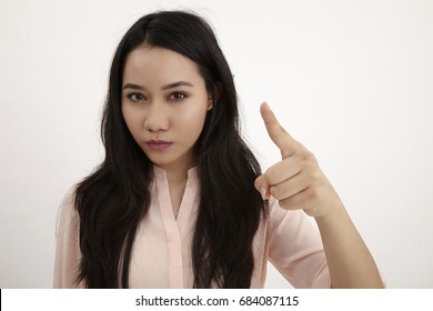 Portrait of a young angry woman pointing finger at camera isolated on a white background - Shutterstock ID 684087115