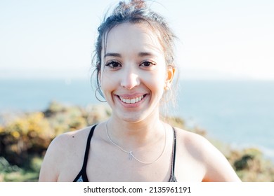 Portrait Of A Young Arab Woman Outdoors On Sport Clothes While Smiling To Camera. Carefree And Freedom Concept. Healthy Lifestyle Doing Exercise Outdoors. Super Smile With Confident Attitude