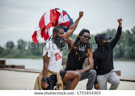 portrait of young armed afroamerican men on demonstration, independent citizens go to protest and defend rights of black people