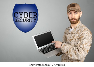 Portrait Of Young Army Soldier With A Laptop