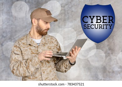 Portrait Of Young Army Soldier With A Laptop