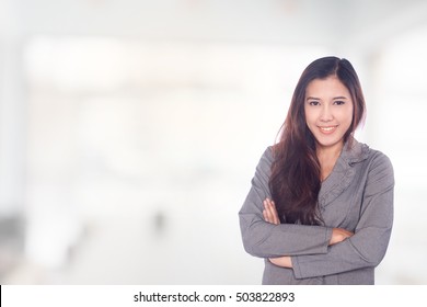 Portrait of young asia business woman 20 - 30 year old in her office.Mixed Asian / Caucasian businesswoman.Positive emotion