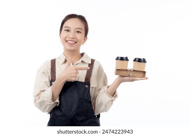 Portrait young asian barista woman wearing apron holding coffee cup and presenting isolated white background, waitress or entrepreneur cheerful and showing, small business or startup, waiter of cafe. - Powered by Shutterstock