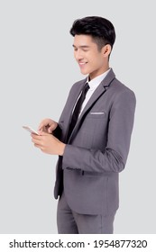 Portrait Young Asian Business Man In Suit Standing Using Smartphone To Internet Isolated On White Background, Businessman Confident Touch Screen Mobile Phone With Success, Communication Concept.