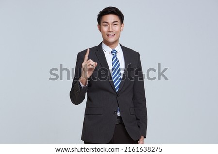 portrait of young Asian businessman good looking and confidently while standing isolated on studio white background.