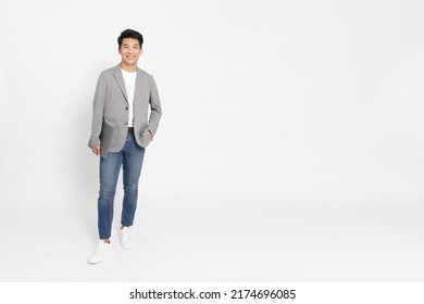 Portrait of young Asian businessman standing and holding laptop computer isolated on white background, Full body composition - Powered by Shutterstock