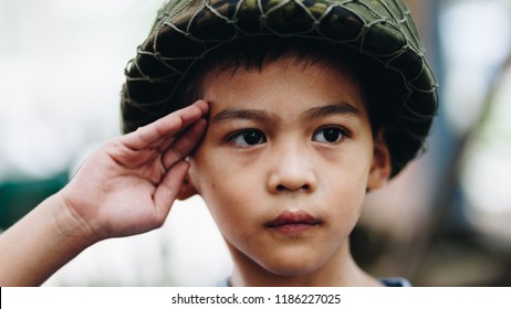 Portrait Of Young Asian Children In Soldier Uniform