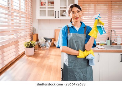 Portrait of a young Asian cleaning service woman worker working in house. Girls housekeeper cleaner, holding foggy spray with liquid detergent, rag with a smile, looking at camera after finish chore. - Shutterstock ID 2366492683