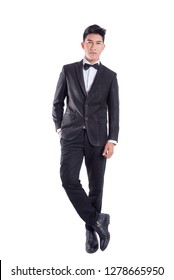 Portrait Of Young Asian Confident Man Dressed In Tuxedo With Bow Tie Isolated On White Background