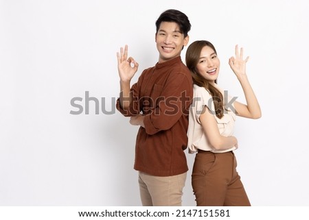 Portrait of young Asian couple showing ok sign isolated on white background, Two people concept