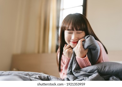 Portrait Young Asian Cute Woman Teen College Student. Girl In Bedroom After Wake Up Stay At Home With Eye Attractive. Has Long Hair And Wear Pink Sweater.