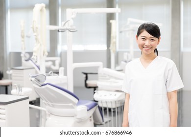 A Portrait Of Young Asian Dentist In Dental Clinic