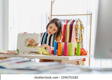 Portrait Young Asian designer woman working by sewing with sew machine at workplace, small business startup, Business owner entrepreneur, modern freelance job lifestyle concept.asean people - Powered by Shutterstock