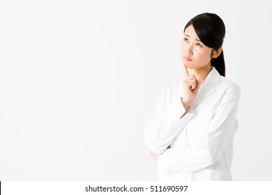 portrait of young asian doctor thinking isolated on white background