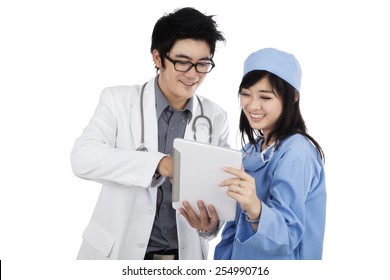 Portrait of young asian doctors discussing their jobs with a digital tablet, isolated on white background