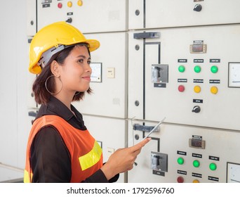 Portrait Of A Young Asian Electric Engineering Woman Is Smiling And Standing In The Energy Control Room.