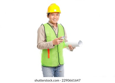 Portrait of young Asian engineer male worker in protective safety uniform helmet standing holding smartphone data technology device isolated on white background. - Powered by Shutterstock