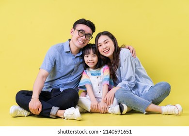 Portrait Of Young Asian Family On Background