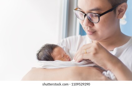 Portrait Of Young Asian Father Holding His Newborn Baby With Copyspace. Healthcare And Medical Nursery Love Lifestyle Together Single Dad Father’s Day Holiday Concept