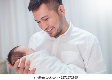 Portrait Of Young Asian Father Holding His Newborn Baby With Copy Space In Hospital Bed. Healthcare Medical Nursery Love Lifestyle Together Single Dad Father’s Day Holiday Concept