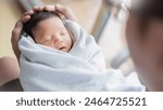 Portrait of young asian father or mother with healthy newborn baby, copy space with bed in hospital background. Single caucasian dad, happy family healthcare and father