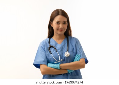 Portrait Of Young Asian Female Doctor Wearing Gloves With Stethoscope Over Neck And Nice Smile, Arms Cross, Isolated On White Background