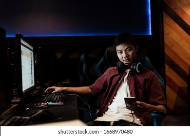 Portrait Of Young Asian Gamer At Internet Cafe. Professional Gamer.