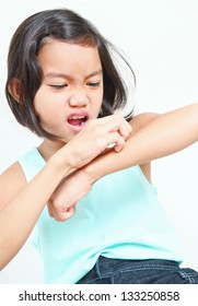 Portrait Of A Young Asian Girl Scratching Her Arm.