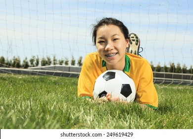 Portrait Of Young Asian Girl With Soccer Ball