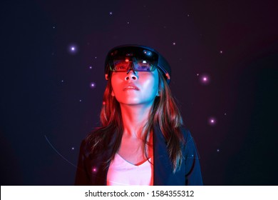 Portrait of young asian girl try hololens in the lab room. Mixed reality future technology concept.