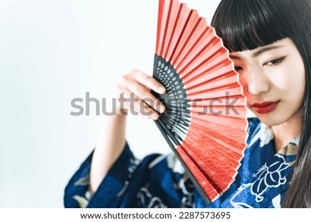 Portrait of young Asian girl wearing Yukata. Japanese traditional summer dress.