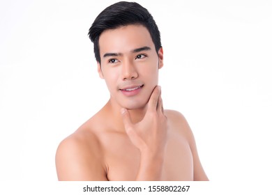 Portrait of young asian handsome man with healthy clean skin touching his chin isolated on white background.
