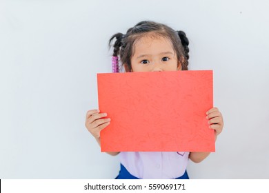 Portrait Of A Young Asian Little Girl Holding A Blank Sign Red Paper On White Background