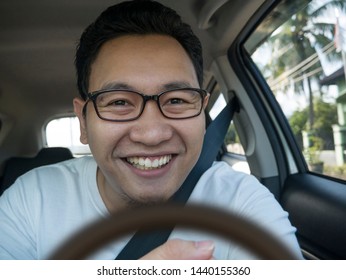 Portrait Of Young Asian Male Driver Smiling Happily, Driver Taking Selfie Photograph, Friendly Ride Car Sharing Driver Waiting For Client