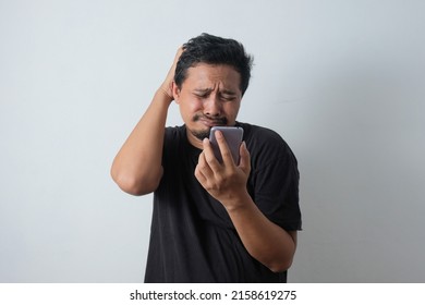 Portrait Of Young Asian Man Crying While Looking Phone