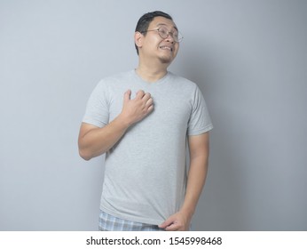 Portrait of young Asian man feel itchy, scratching his body in pain