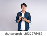 Portrait of young Asian man holding travel camera and posing on white background