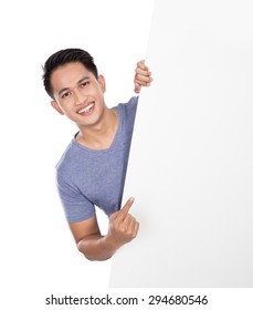 A Portrait Of A Young Asian Man Holding A Blank Banner Isolated On White Background. Peeping From Behind