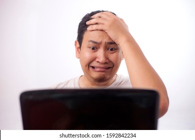 Portrait Of Young Asian Man Looked Afraid Terrified Worried When Looking At Laptop, Gasp Gesture Cant Believe What He See On Internet