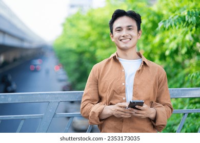 Portrait of young Asian man outside - Powered by Shutterstock