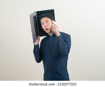 portrait young Asian man talking smartphone or mobile phone and hand holding laptop on white background