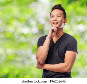 Portrait Of Young Asian Man Thinking At Park