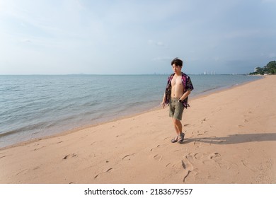 Portrait Of Young Asian Man Walking By At The Beach On Summer Vacation