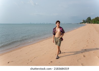 Portrait Of Young Asian Man Walking By At The Beach On Summer Vacation