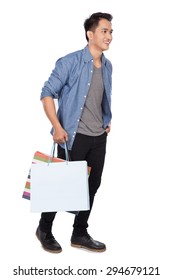 A Portrait Of Young Asian Man Walking And Holding Shopping Bags, Full Body