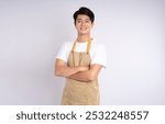 Portrait of young asian man wearing apron and posing on white background