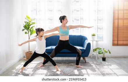 Portrait Of Young Asian Mother  Daughter Prepare For Stretching Post In Yoga Meditation. Mom And Little Girl Toddler Yoga Exercise On Yoga Mat At Home. Together Lifestyle, Mother's Day Concept